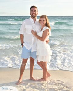 a couple standing on the beach.