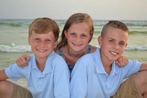 kids smiling in beach photo