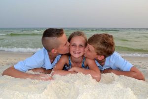 adorable pose - brothers kissing sister on cheek