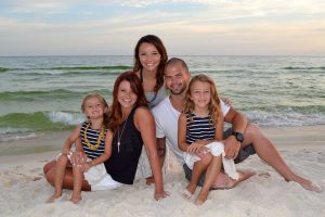 family lounging on beach