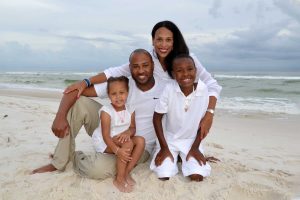 Smiling family sitting on the beach