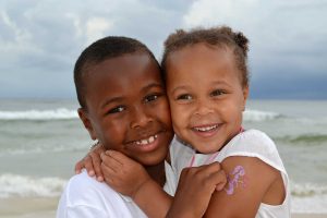 Two kids smiling for the camera