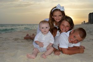 kids in front of setting sun