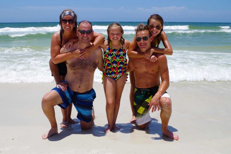 Cute family posing on the beach