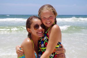 Mom and daughter having fun on the beach - We offer daytime beach photos in Panama City Beach, Destin, Fort Walton and Miramar Beach