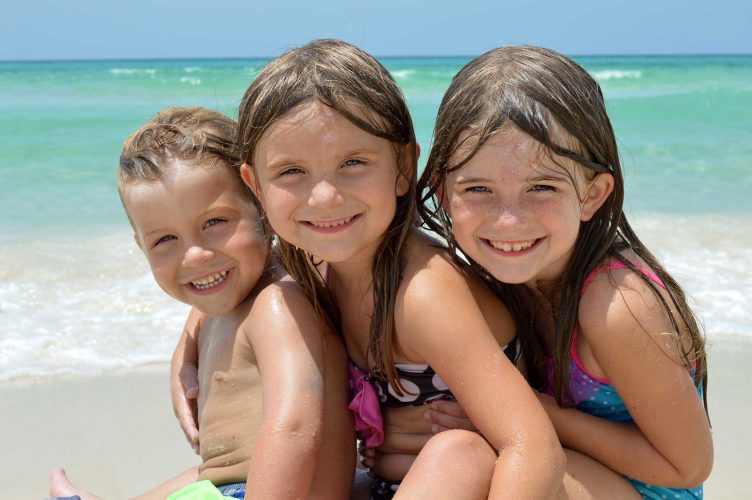 photo of happy kids playing on the beach