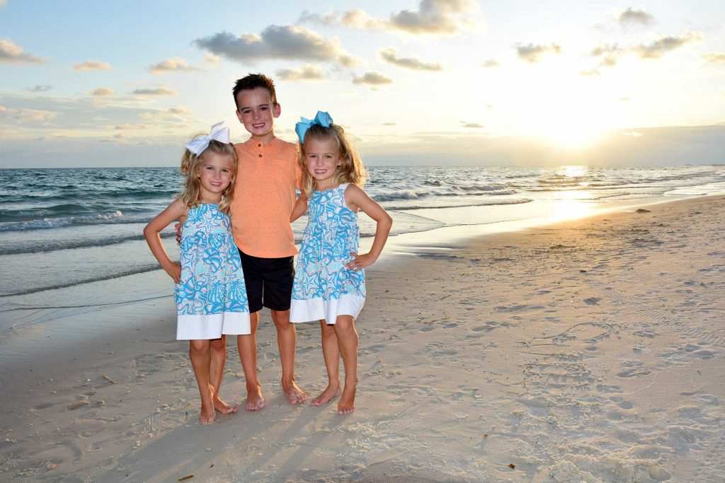 Cute kids smiling for their Panama City Beach sunset photographer.