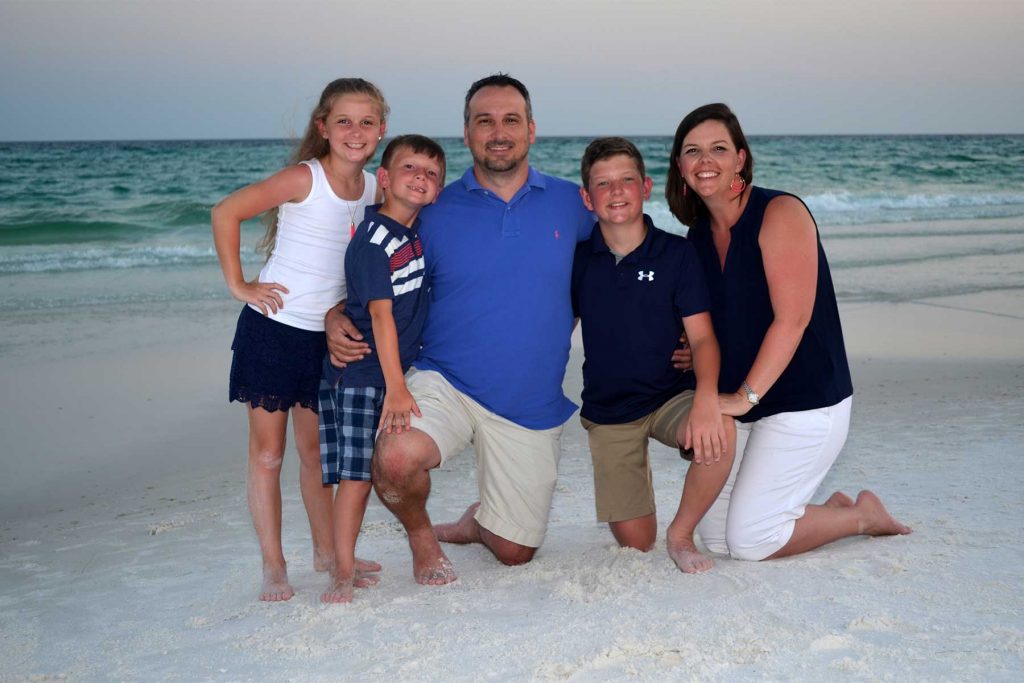 Wearing shorts, golf shirts, tank tops for their beach photo