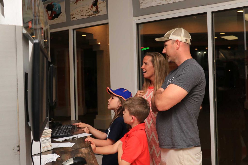 Family choosing photos at our location in Panama City Beach, FL