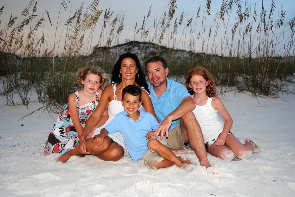 Family on Miramar Beach wearing coordinating outfits.