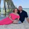 couple on the beach under the pier in Panama City Beach, FL.
