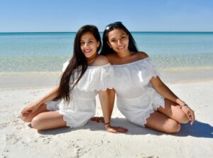 couple smiling for the camera in a morning beach photo