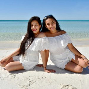 couple smiling for the camera in a morning beach photo