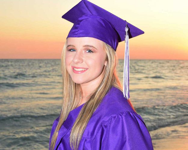 girl wearing cap and gown for her senior photos