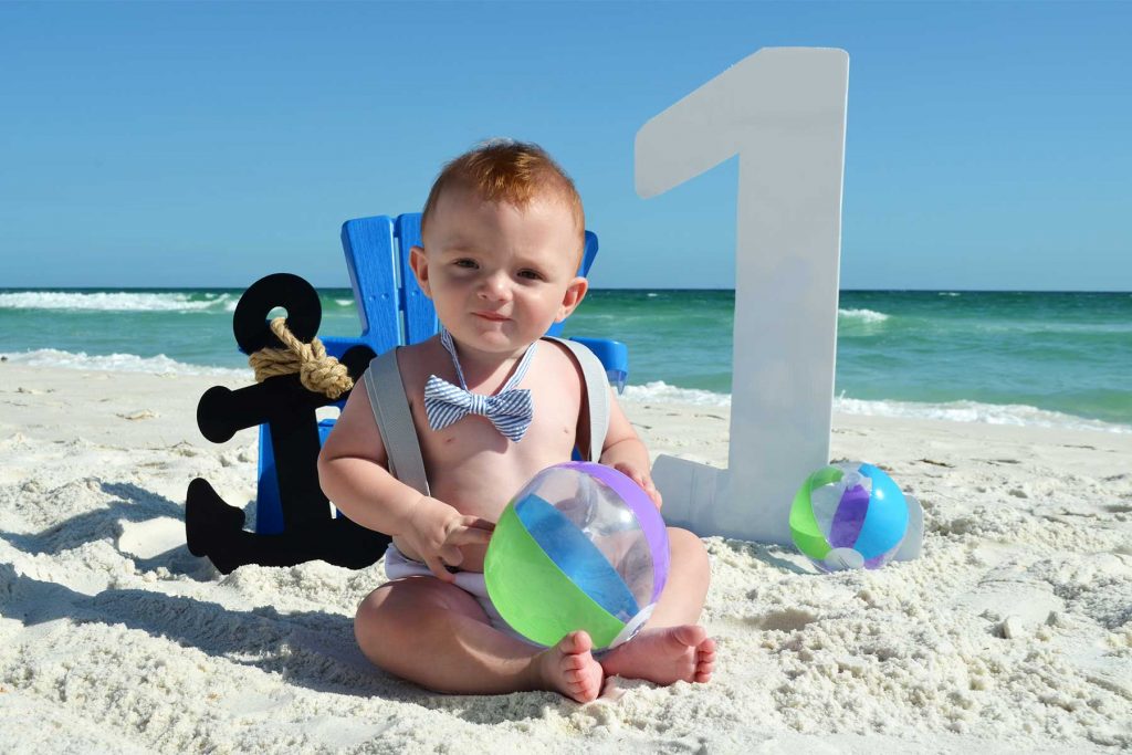 baby's first birthday photo on the beach