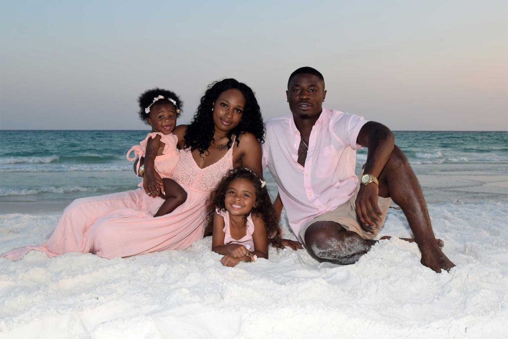 Professional portrait of family and baby at the beach