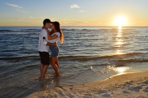 photo of couple kissing in front of sunset on Panama City Beach, Florida