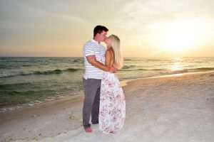 Couple kissing in their sunset beach photo on Panama City Beach