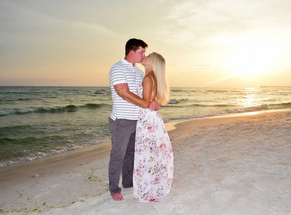 Couple kissing in their sunset beach photo on Panama City Beach