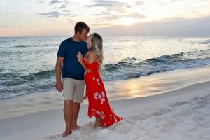 couple walking on the beach at sunset