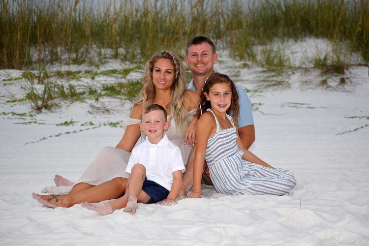 family photo at sunset on Panama City Beach, FL.