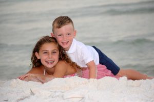 siblings posing on the shore