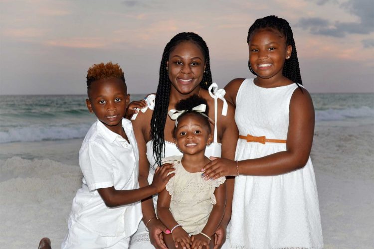 Smiling family getting their photo taken at the beach. We also take photos in Destin, Fort Walton Beach and Miramar Beach, Florida.