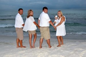 family posing on the beach