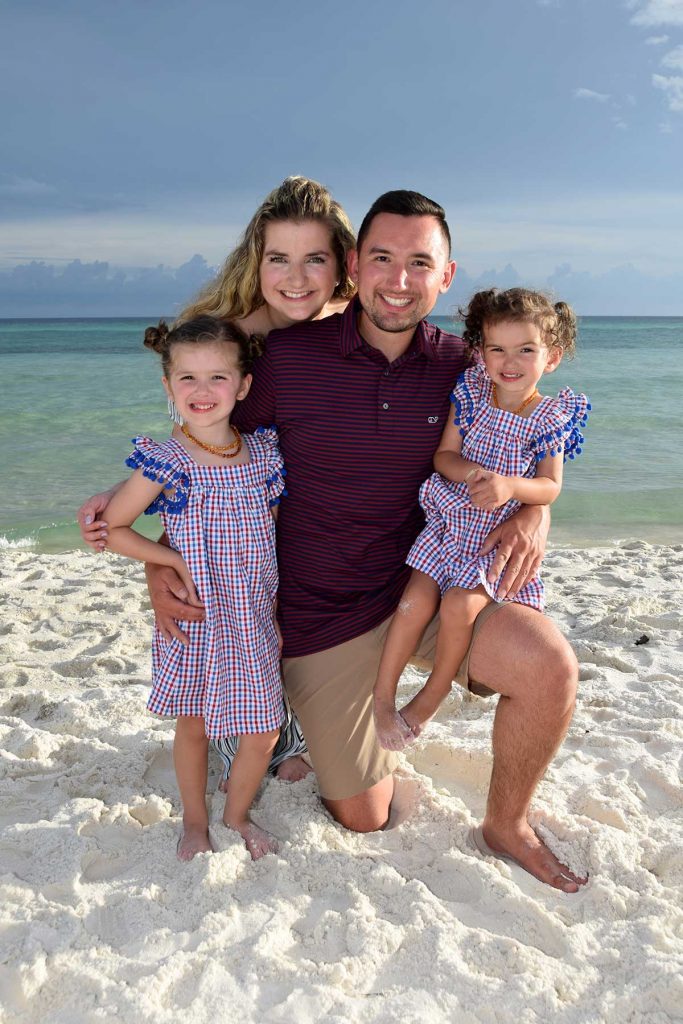 Smiling family on the beach at the golden hour - Find photographers near you for keepsake photos like this