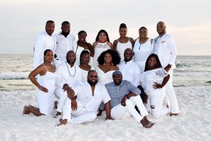 Large group posing for a beach photo. We offer beach photos in Destin, Ft Walton, Miramar and PCB.