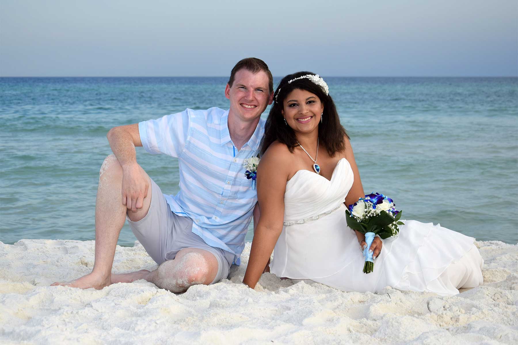 Panama City Beach wedding photo with couple sitting on the beach