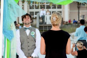 Our photographer shot this photo of the groom waiting for the bride to come down the aisle. Our photographers are available for formal and casual wedding photos in Panama City Beach, Destin, Ft Walton Beach, and Miramar Beach FL.