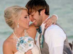 A happy couple embrace in this wedding photo