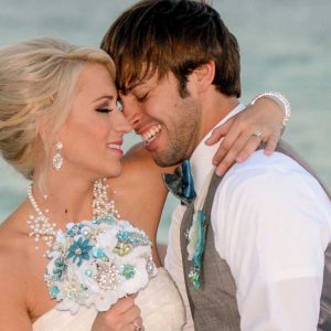 A happy couple embrace in this wedding photo