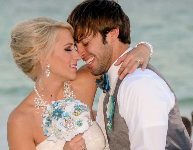 A happy couple embrace in this wedding photo