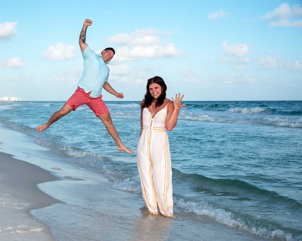 Photo of a surprise proposal in Panama City Beach - beautiful blue water, a happy couple and the engagement ring.