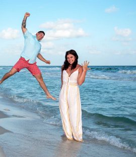 Photo of a surprise proposal in Panama City Beach - beautiful blue water, a happy couple and the engagement ring.