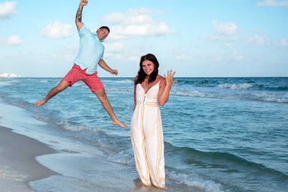 Photo of a surprise proposal in Panama City Beach - beautiful blue water, a happy couple and the engagement ring.