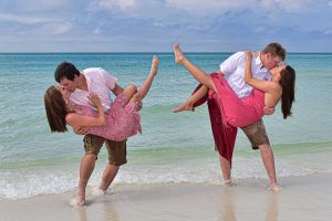 two couples kissing