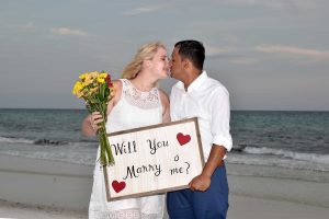 couple with will you marry me sign