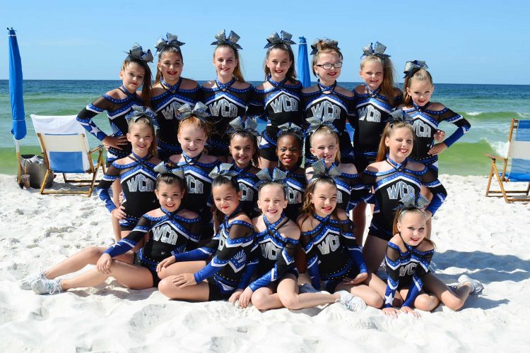 Cheerleading squad getting their team portrait at the beach