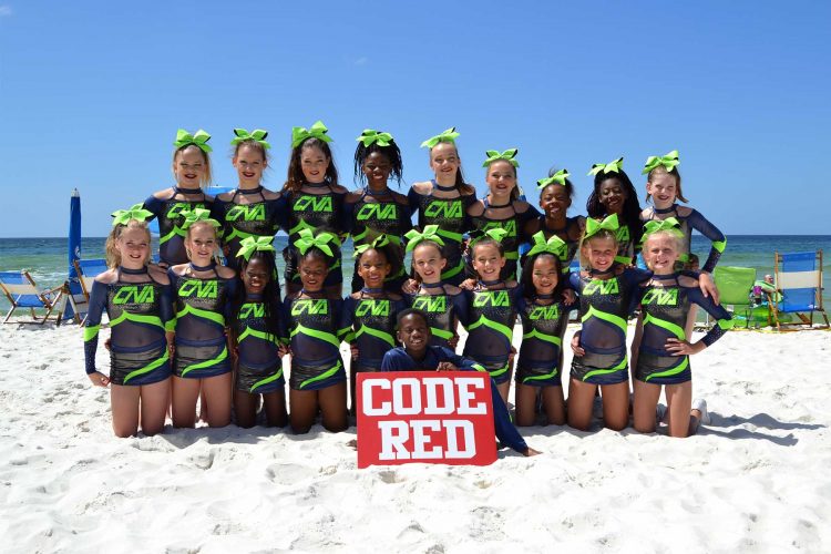 Cheerleaders posing in the sand on the beach