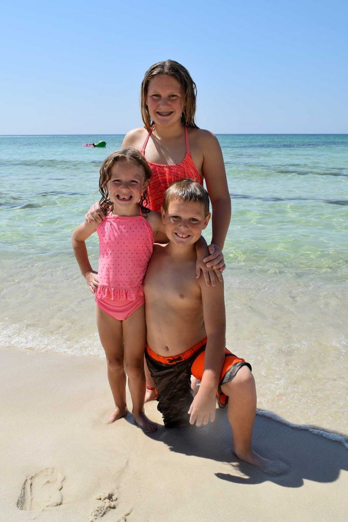 kids posing on the beach