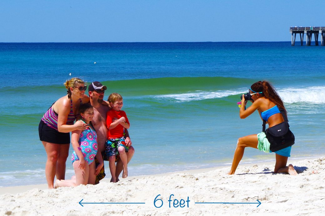 One of our photographers, April, taking family beach photos. Visit PCB this summer for a safe, fun vacation.