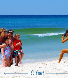 One of our photographers, April, taking family beach photos. Visit PCB this summer for a safe, fun vacation.