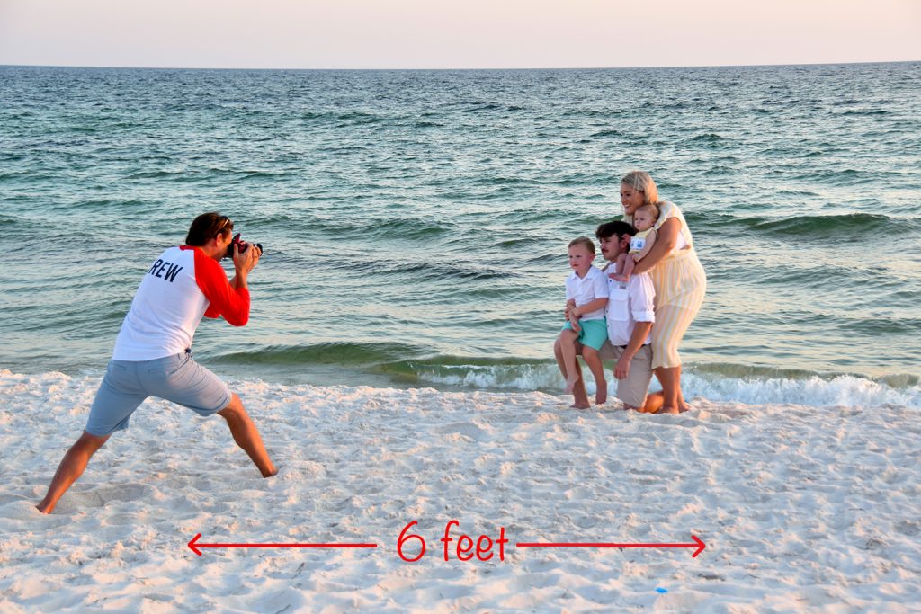 Our beach photographer snapping vacation pics for a family in Panama City Beach, FL. He is six (6) feet away.