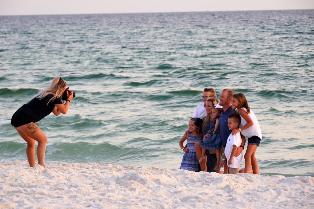 Panama City Beach photographer Stazia snapping a photo of a family