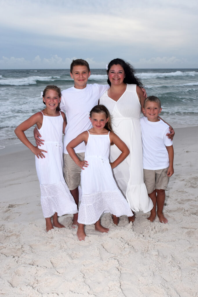 beautiful family posing in front of waves