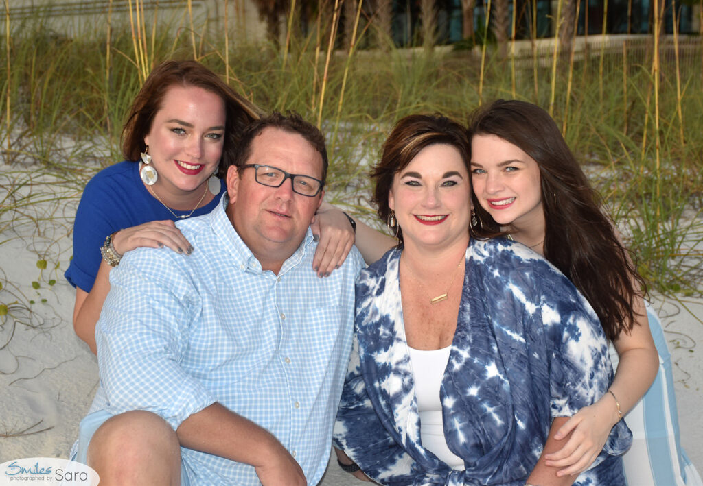 Posing for beach photos by sea oats in PCB.