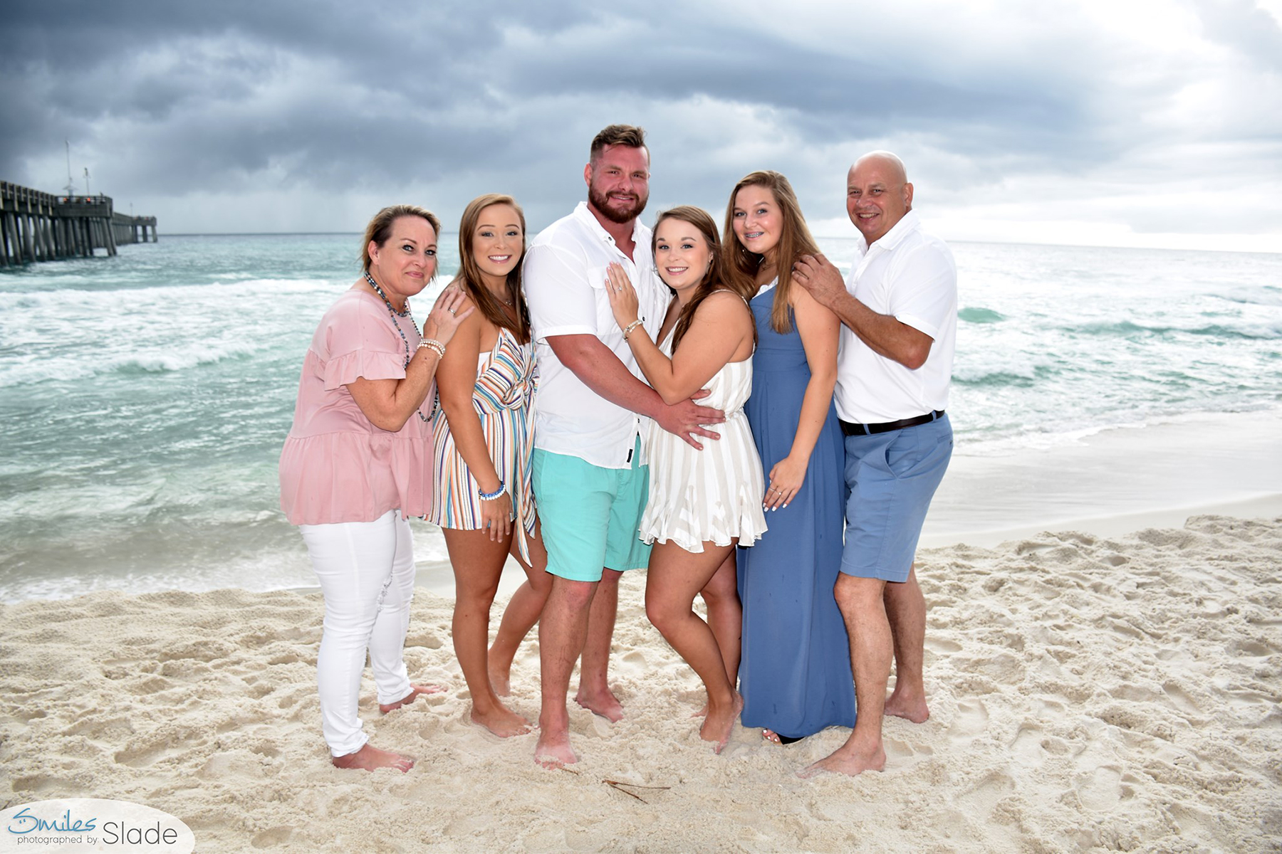 Family photographer in Panama City Beach poses family near pier park.